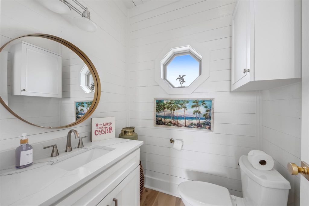 Powder room with quartz vanity and shiplap walls