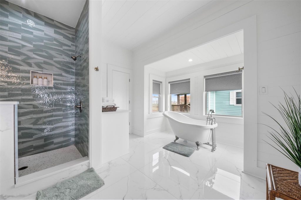 Tiled walk-in shower alongside a freestanding soaking tub