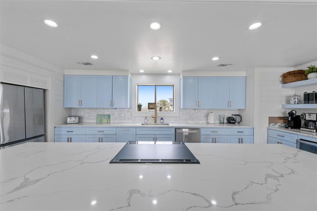 Quartz kitchen counters and tile backsplash